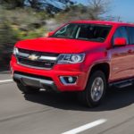A red 2015 Chevy Colorado Z71 is shown leaving a used Chevy dealer.