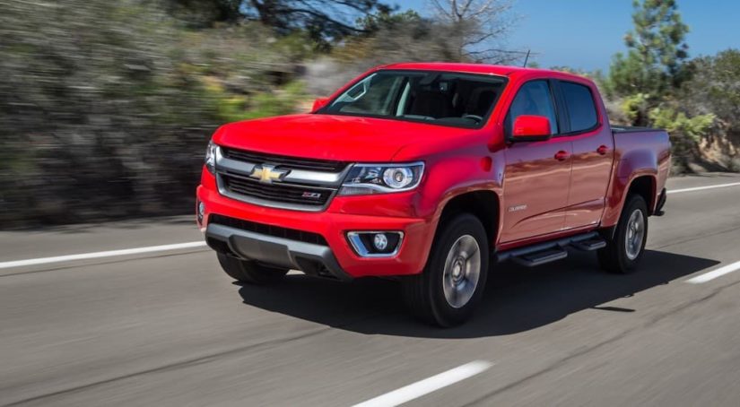 A red 2015 Chevy Colorado Z71 is shown leaving a used Chevy dealer.