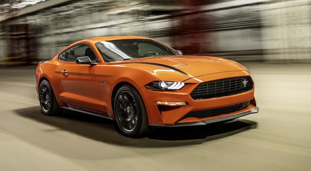 An orange 2022 Ford Mustang Ecoboost HPP is shown from the front at an angle.