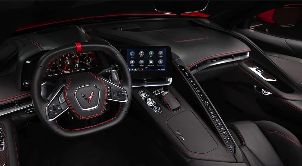 A close up of the interior of 2022 Chevy Corvette shows the steering wheel and center console.