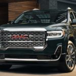 A black 2022 GMC Acadia Denali is shown parked in a driveway.