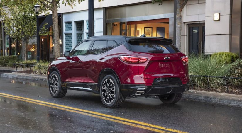 A red 2022 Chevy Blazer is shown from the rear at an angle on a city street.