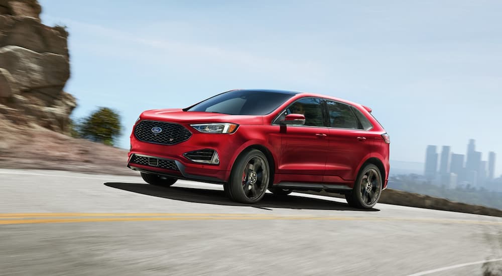 A 2022 Ford Edge ST is shown from the front at an angle while dring on a mountain road during a 2022 Chevy Blazer vs 2022 Ford Edge comparison.
