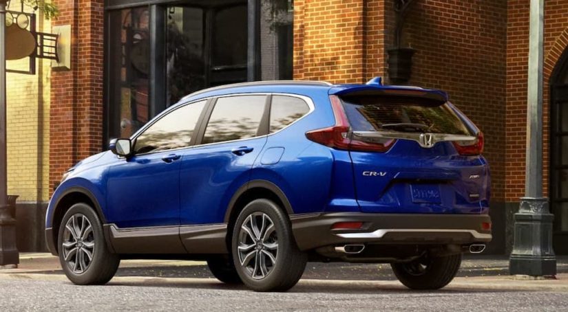 A blue 2020 Honda CR-V is shown from the rear at an angle after leaving a Honda dealer.