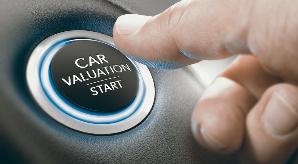 A close up shows a button being pushed labeled 'car valuation start.'