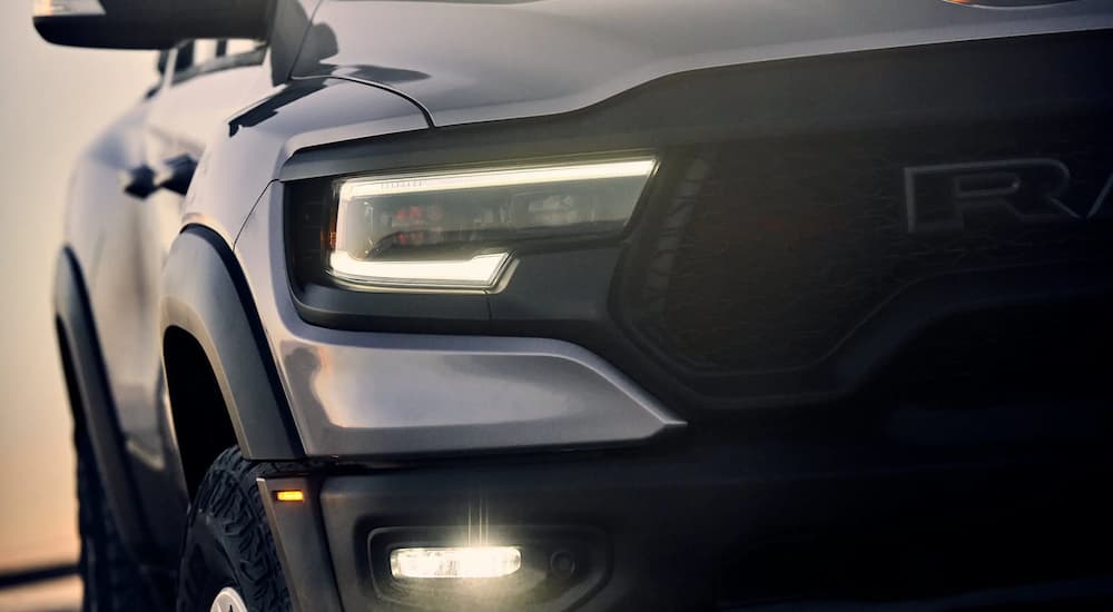 A close up of the passenger headlight on a silver 2022 Ram 1500 TRX is shown.