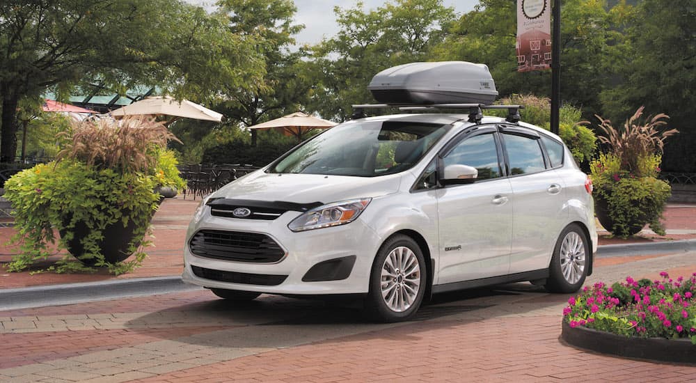 A white 2017 Ford C-Max Hybrid SE is shown parked on a brick pathway.