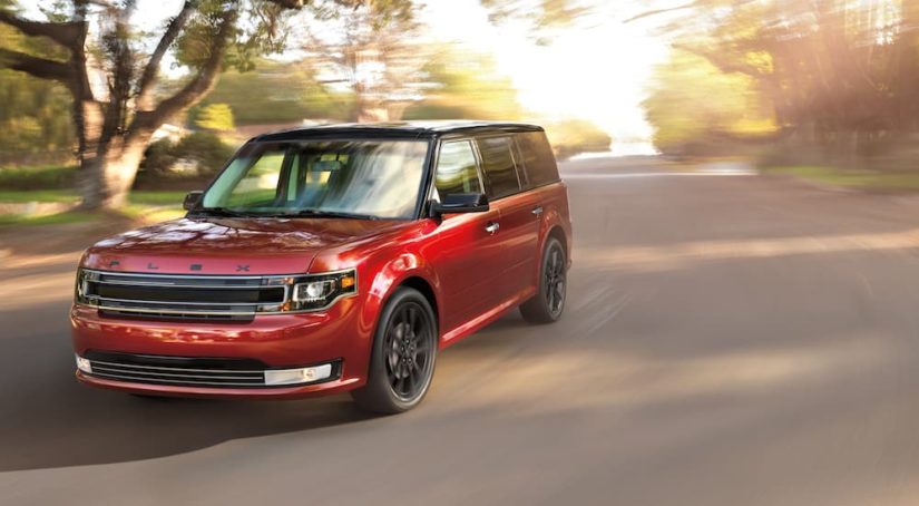 A red 2019 Ford Flex Limited is shown rounding a corner after leaving a Rhinebeck Ford dealer.