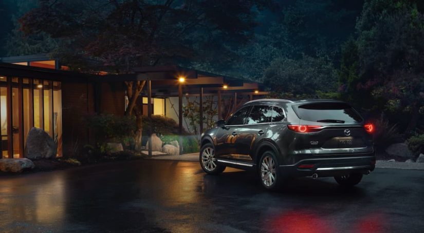 A grey 2021 Mazda CX-5 is shown outside a house at night.