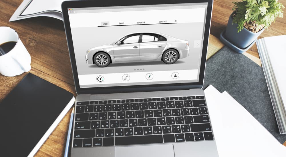 A silver car is shown on a laptop screen.