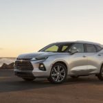 A silver 2023 Chevy Blazer Premier is shown from the side while parked on the beach.