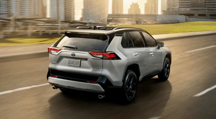 A silver 2022 Toyota RAV4 is shown from the rear at an angle on the highway.