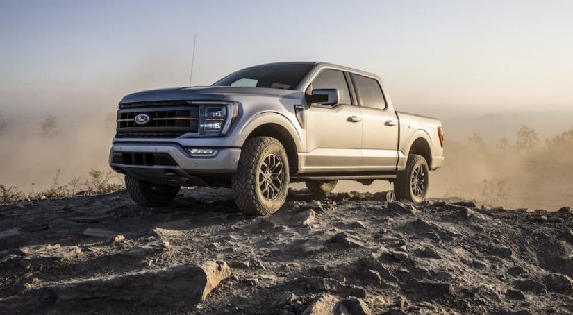A silver 2022 Ford F-150 Tremor is shown on top of a rocky area.