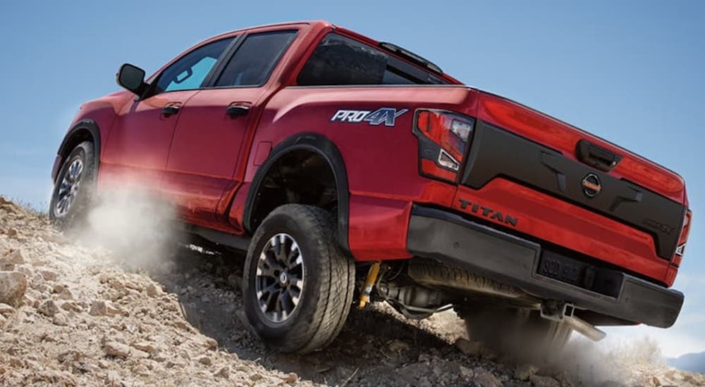 A red 2022 Nissan Titan Pro4X is shown from the rear at a low angle.