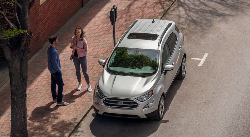 A silver 2022 Ford EcoSport SE is shown from a high angle on a city street.