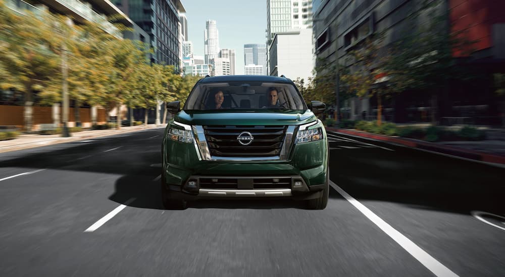 A green 2022 Nissan Pathfinder is shown from the front during a 2022 Ford Explorer vs 2022 Nissan Pathfinder comparison.