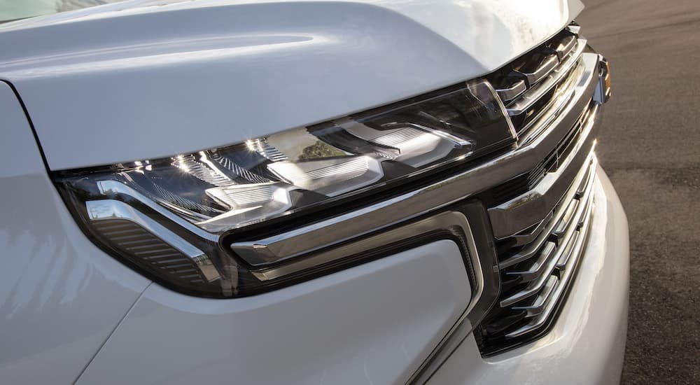 A close up shows the passenger side headlight on a 2023 Chevy Suburban.