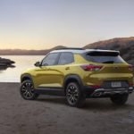 A yellow 2023 Chevy Trailblazer is shown from the rear at an angle while parked on a lake-shore.