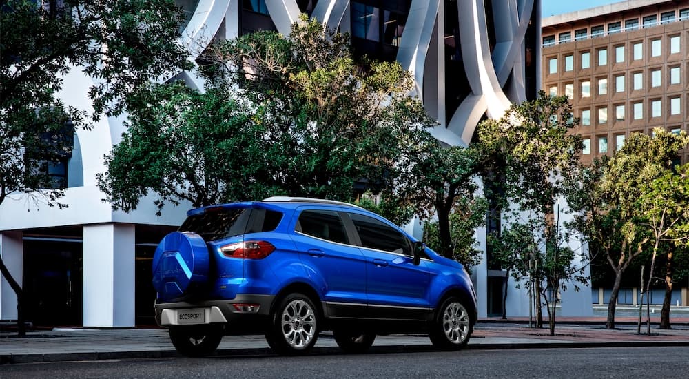 a blue 2022 Ford Ecosport is shown from the rear at an angle on a city street.