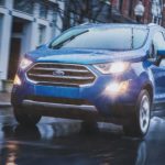 A blue 2022 Ford Ecosport is shown from the front at an angle in the rain.