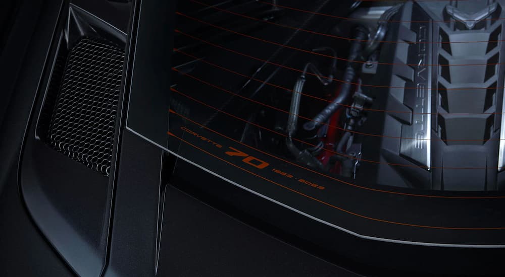 A close up shows glass etching on a black 2023 Chevy Corvette 3LT 70th Anniversary Edition.