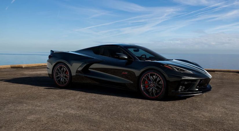 A black 2023 Chevy Corvette 3LT 70th Anniversary Edition is shown overlooking the ocean.