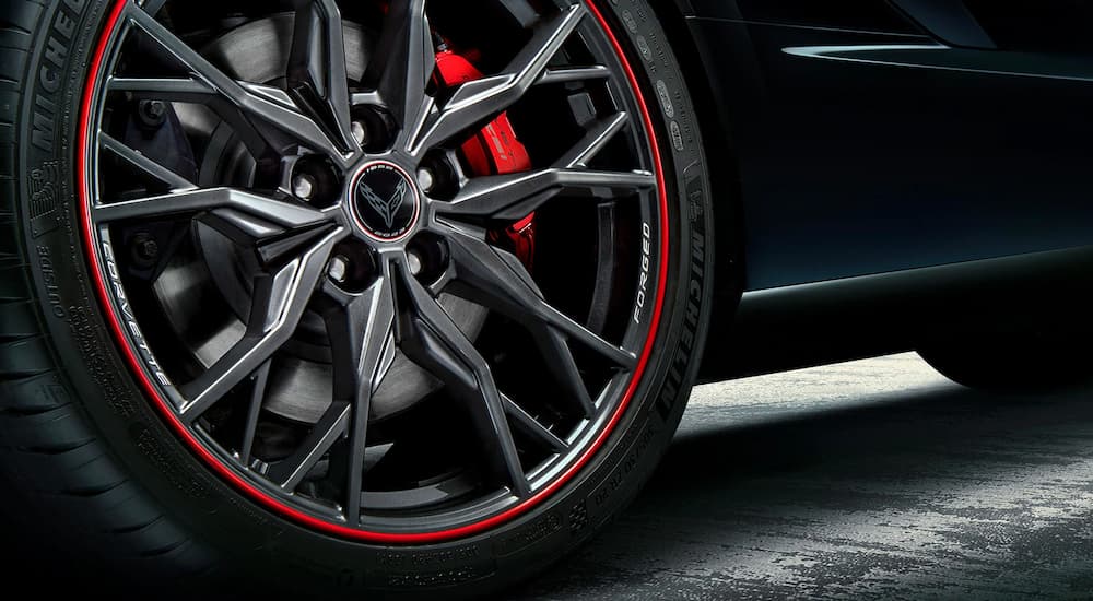 A close up shows the forged rim on a popular Chevrolet, a black 2023 Chevy Corvette 3LT 70th Anniversary Edition.