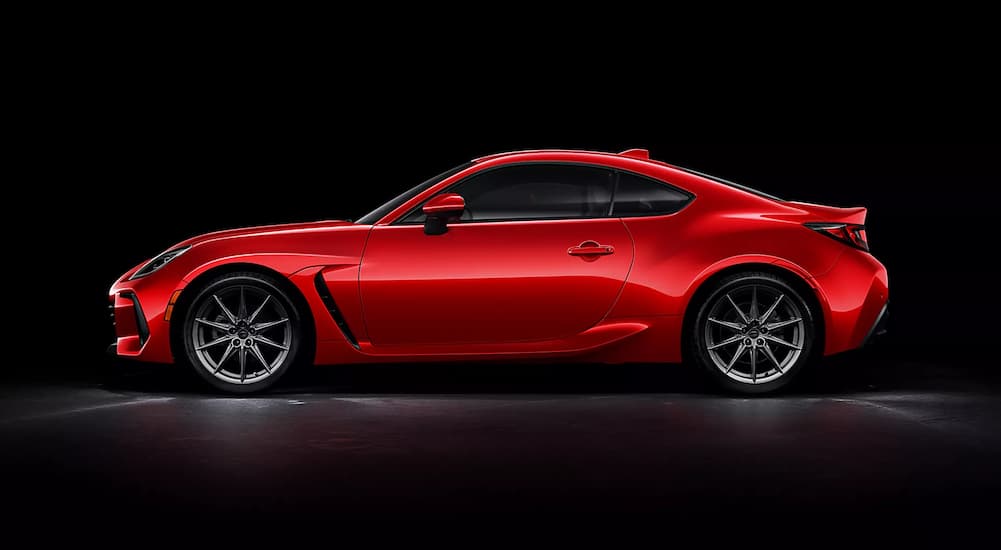 A red 2023 Subaru BRZ Limited is shown from the side against a black background.