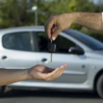 A person is shown passing a car key after deciding to search 'sell your car.'