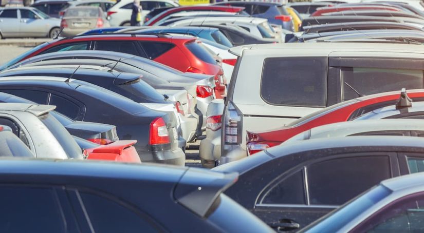 Two rows of used cars are shown at a used car dealership near you.