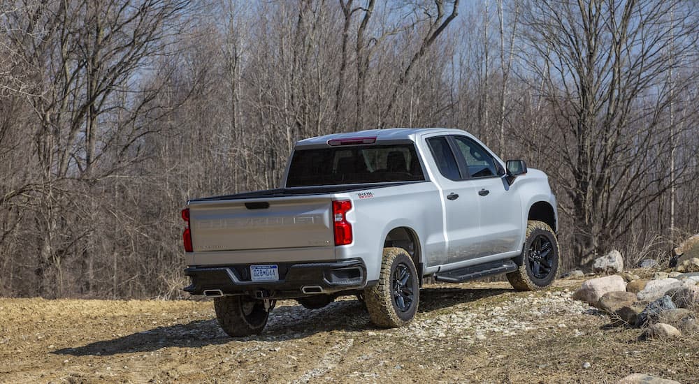 A grey 2022 Chevy Silverado 1500 Custom TrailBoss is shown from the rear at an angle.