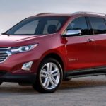 A red 2021 Chevy Equinox is shown from the front at an angle.