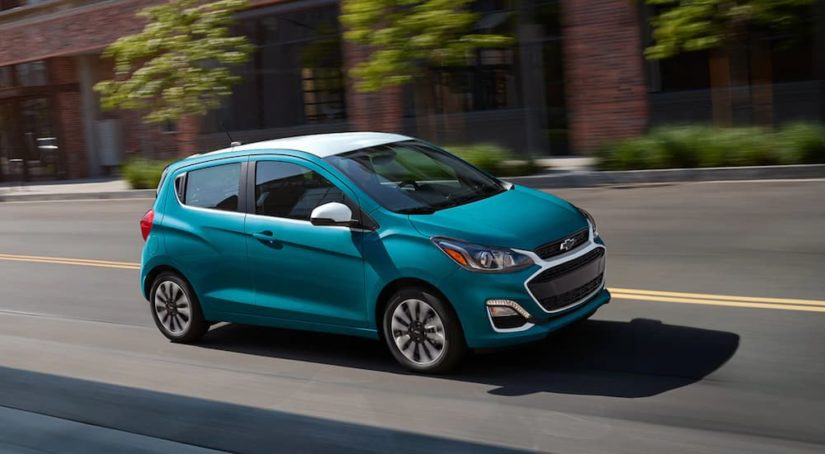 A blue 2021 Chevy Spark is shown from the side while driving after leaving a Chevy dealer near you.