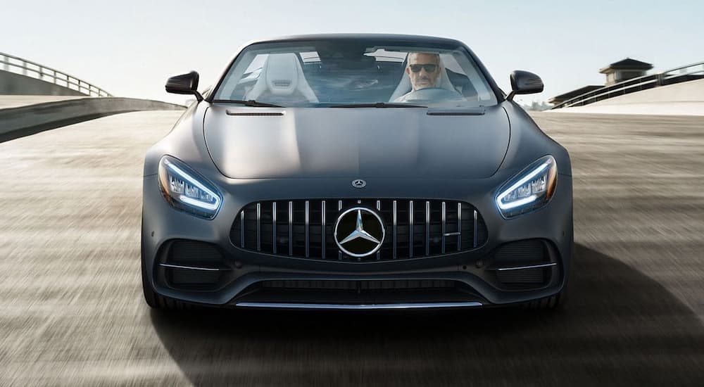 A grey 2021 Mercedes-Benz AMG GT is shown from the front on a bridge.