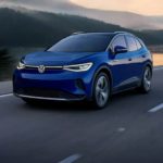 A blue 2022 Volkswagen ID.4 is shown from the front at an angle while driving.