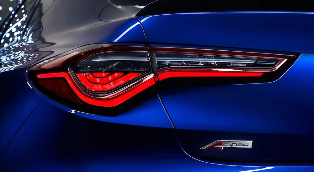 A close up shows the driver side taillight on a blue 2022 Acura TLX A Spec.