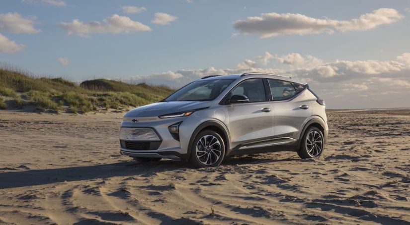 A silver 2023 Chevy Bolt EUV is shown from the side at an angle while parked on a beach.