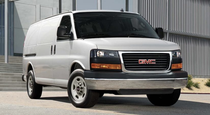 A white 2022 GMC Savana Cargo Van is angled right.