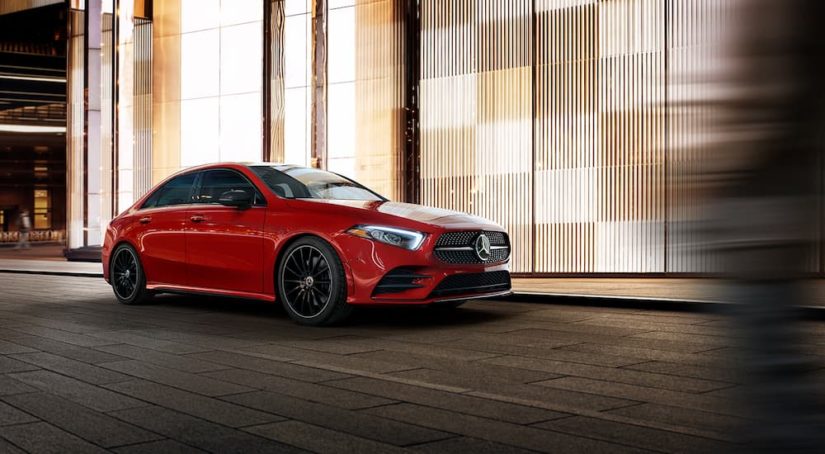 A red 2022 Mercedes-Benz A-Class is shown in front of a modern wall.