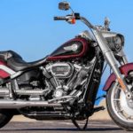 A red 2022 Harley Davidson Fat Boy is shown from the side while parked.