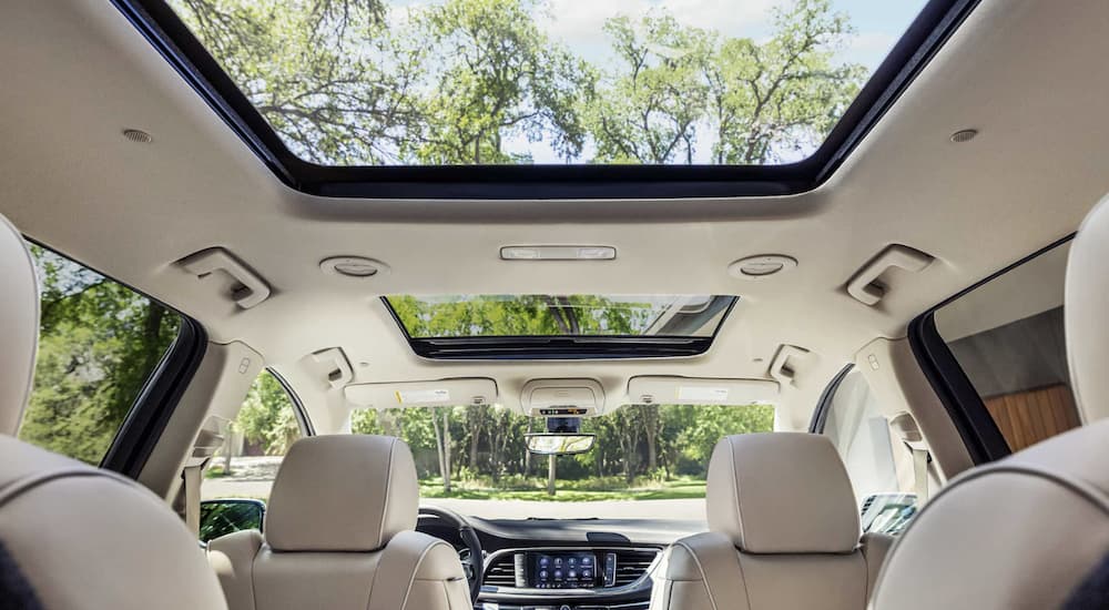 The white interior of a 2023 Buick Enclave is shown.