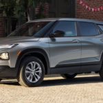 A grey 2023 Chevy Trailblazer is shown parked on the side of a city street.