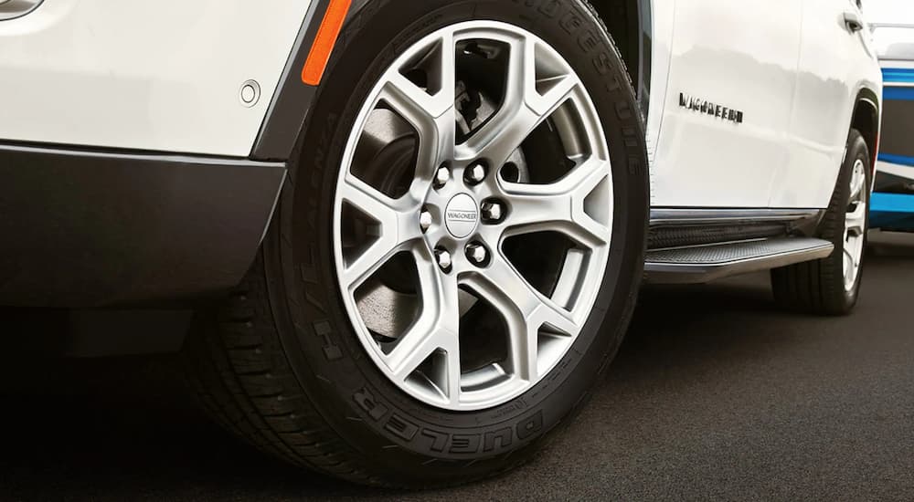A close up of the tire on a white 2023 Wagoneer L is shown. 