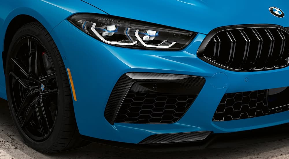 A close up of the grille on a blue 2022 BMW M8 Competition Coupe is shown.