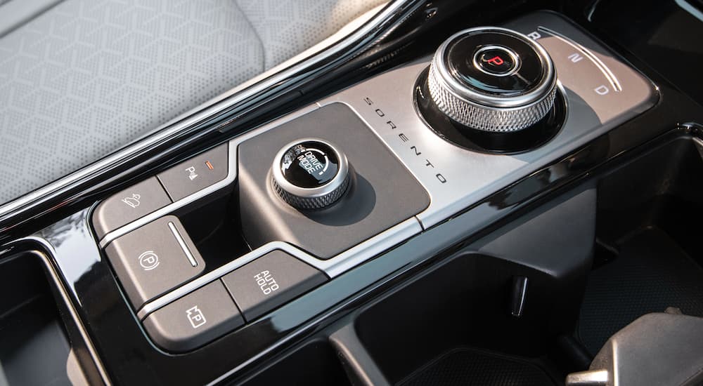 A close up shows the drive mode button in a 2022 Kia Sorento Hybrid.