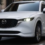 A white 2023 Mazda CX-5 is shown leaving a Mazda CX-5 dealer near you.
