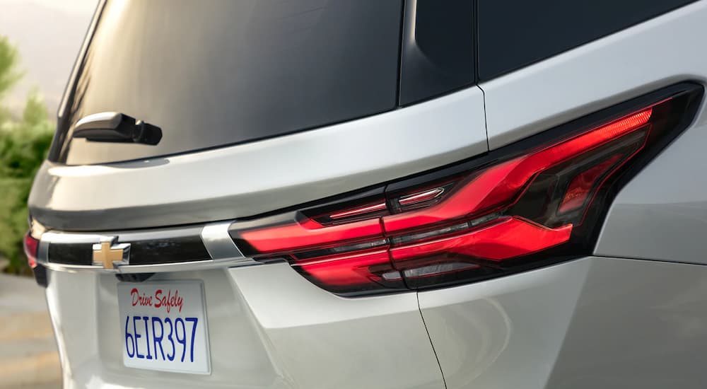 A close up of the taillights on a grey 2023 Chevy Traverse is shown at a SUV dealer.