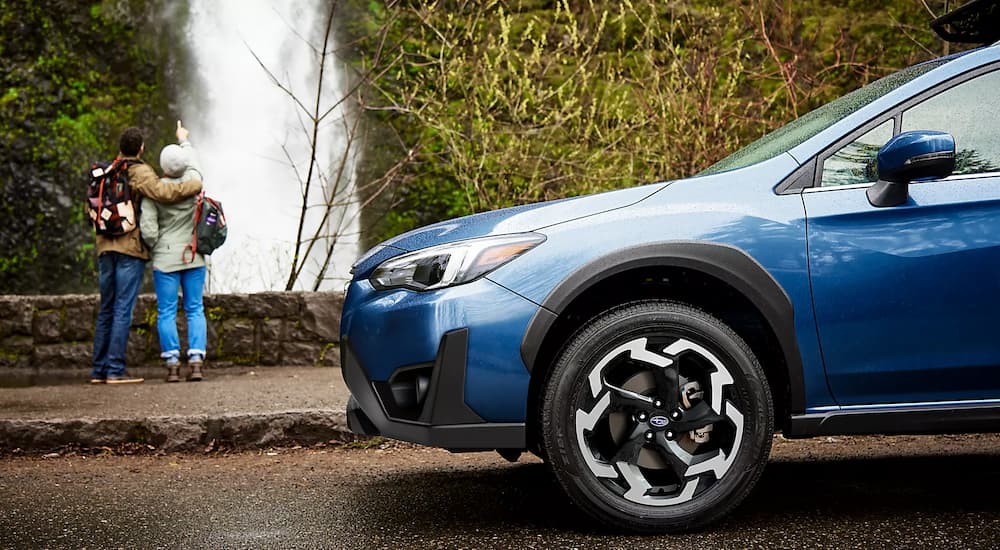 The front half of a blue 2023 Subaru Crosstrek Limited is shown after leaving a Subaru Crosstrek dealer.