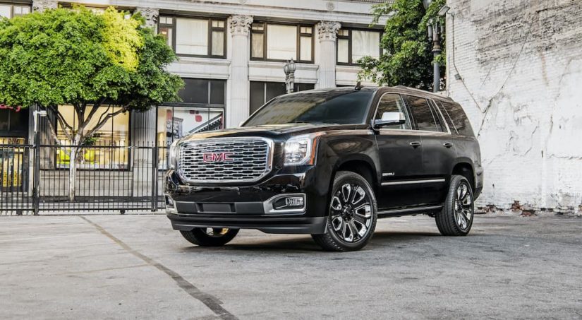 A black 2018 GMC Yukon Denali Ultimate is shown on a lot after leaving a used GMC dealer.