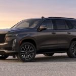 A grey 2023 Cadillac Escalade is shown parked on a salt flat.